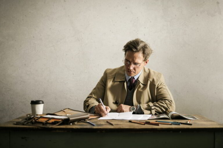IntroNeur.com Introvert Entrepreneurs man writing at a desk